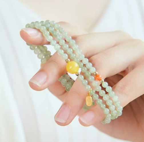 The Hetian jade bracelet features a ethnic style with three layers of natural high-ice green jade and amber in the south red color