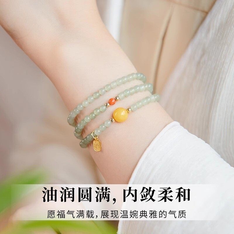 The Hetian jade bracelet features a ethnic style with three layers of natural high-ice green jade and amber in the south red color