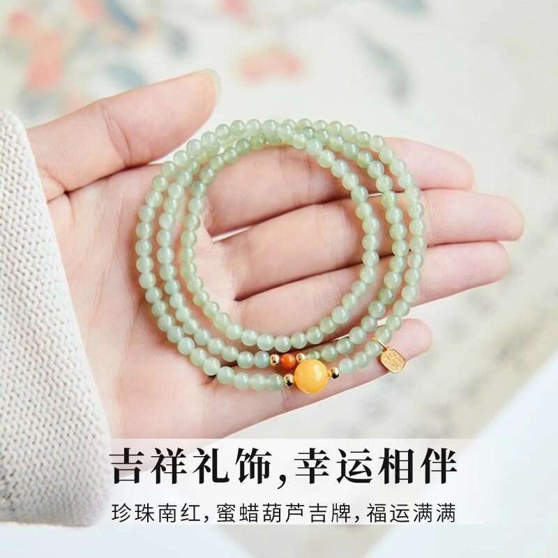 The Hetian jade bracelet features a ethnic style with three layers of natural high-ice green jade and amber in the south red color