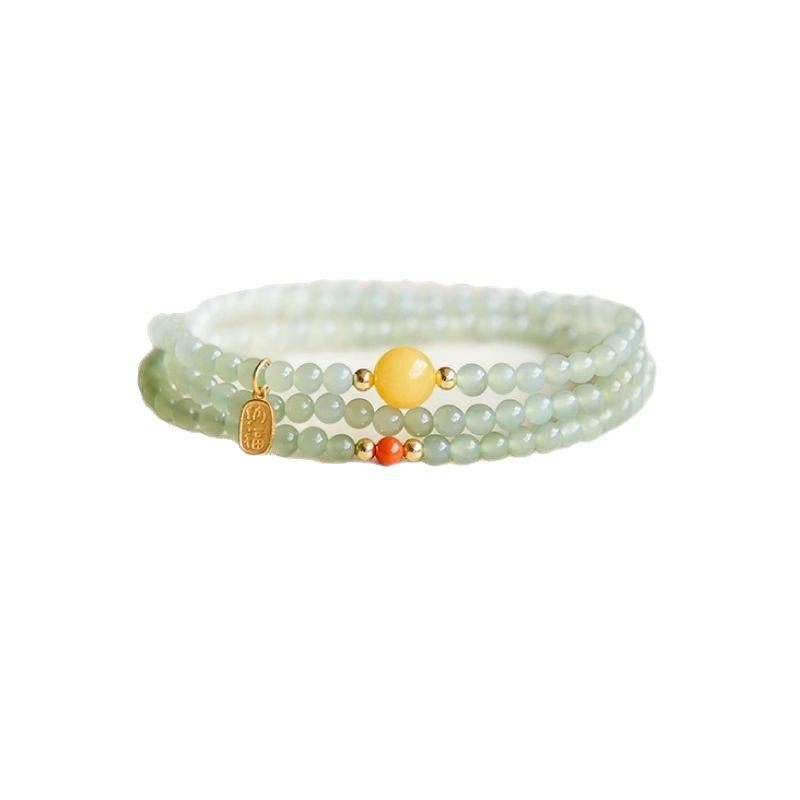 The Hetian jade bracelet features a ethnic style with three layers of natural high-ice green jade and amber in the south red color