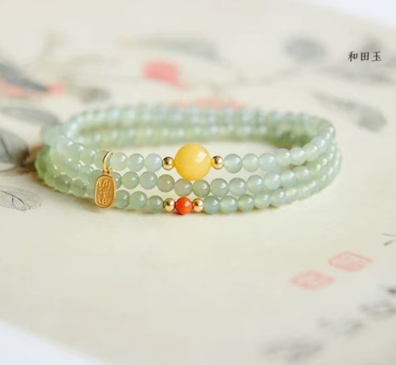 The Hetian jade bracelet features a ethnic style with three layers of natural high-ice green jade and amber in the south red color