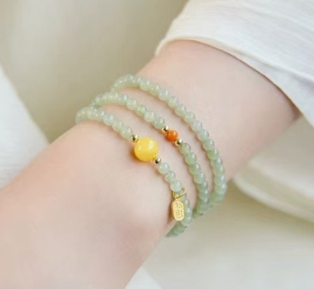 The Hetian jade bracelet features a ethnic style with three layers of natural high-ice green jade and amber in the south red color